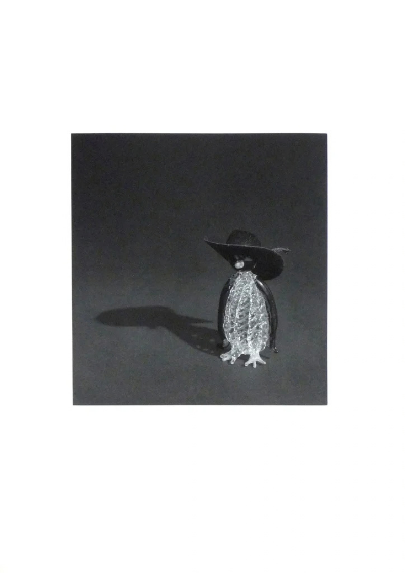 Penguin with a black hat by Liliana Porter